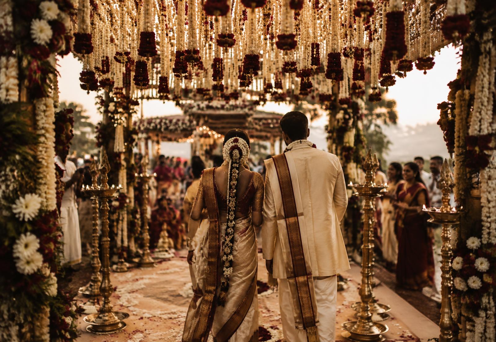 A couple entering their South Indian wedding celebration